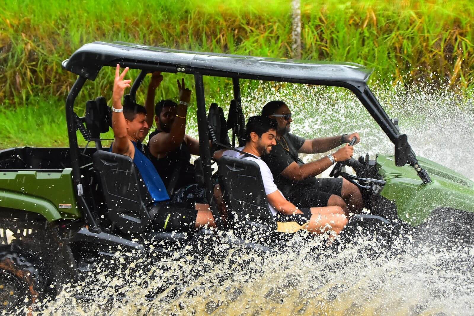 Splashing through rivers on a jungle ATV adventure. Splashing through rivers on a jungle ATV adventure.