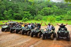 Friends ready to explore the jungle on their ATV adventure.