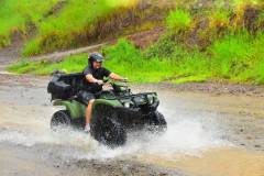 Conquering muddy trails on an ATV jungle adventure.